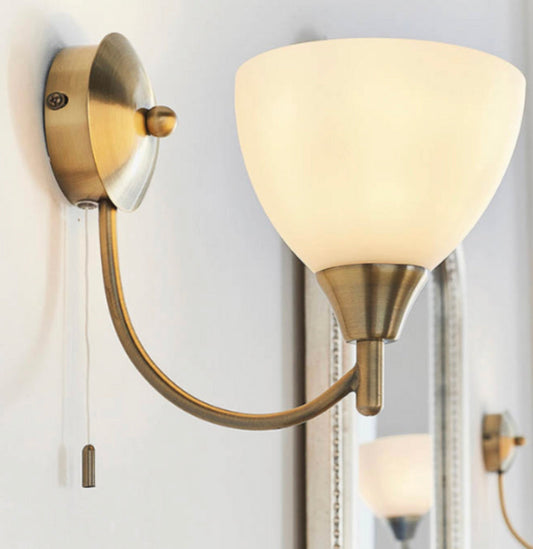Brighten your home with the Endon Alton Wall Light – antique brass finish, opal glass shade, and a convenient pull cord switch. Perfect for bedrooms, hallways & living rooms. Shop now for affordable luxury lighting at LuxuryForLess.uk!