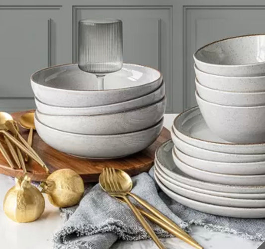 Over and Back 16-piece stoneware dinnerware set with plates and bowls in a modern neutral glaze, displayed on a dining table