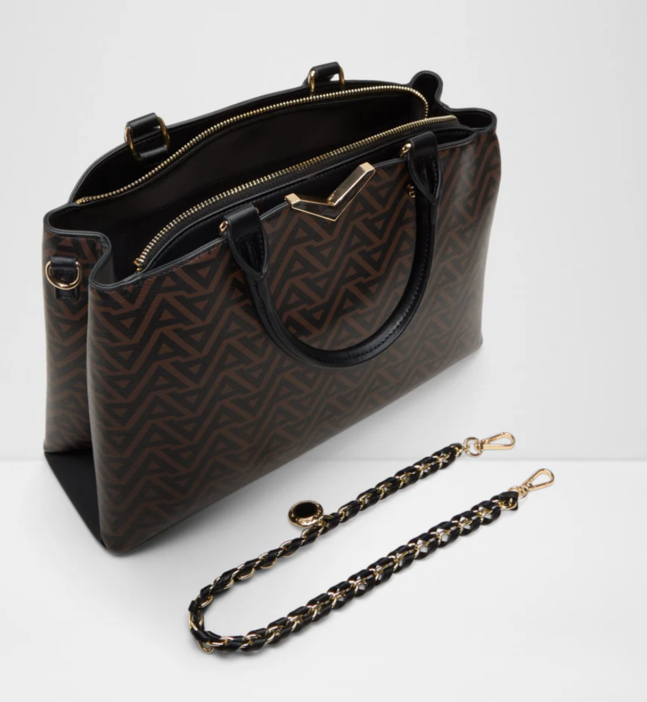 Open view of the ALDO Viviana brown patterned tote bag showing spacious interior, secure zip compartment, sturdy handles and detachable decorative chain.