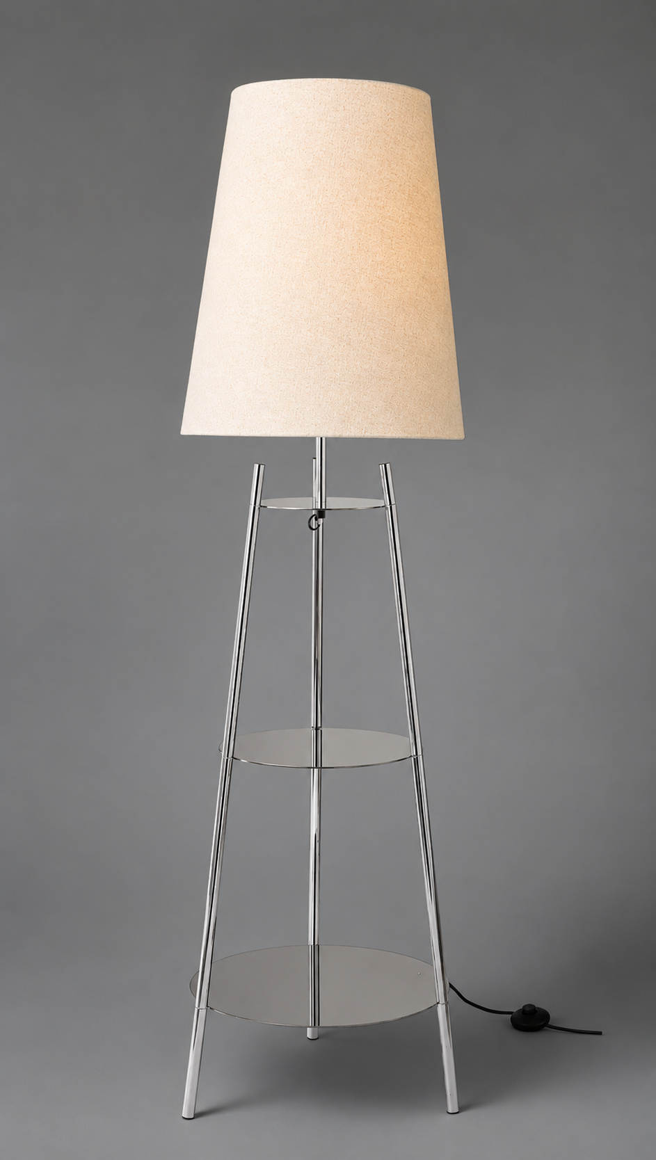 The Very Collection metal tapered shelf floor lamp with chrome frame, clear glass shelves and cream fabric shade on a grey background 
