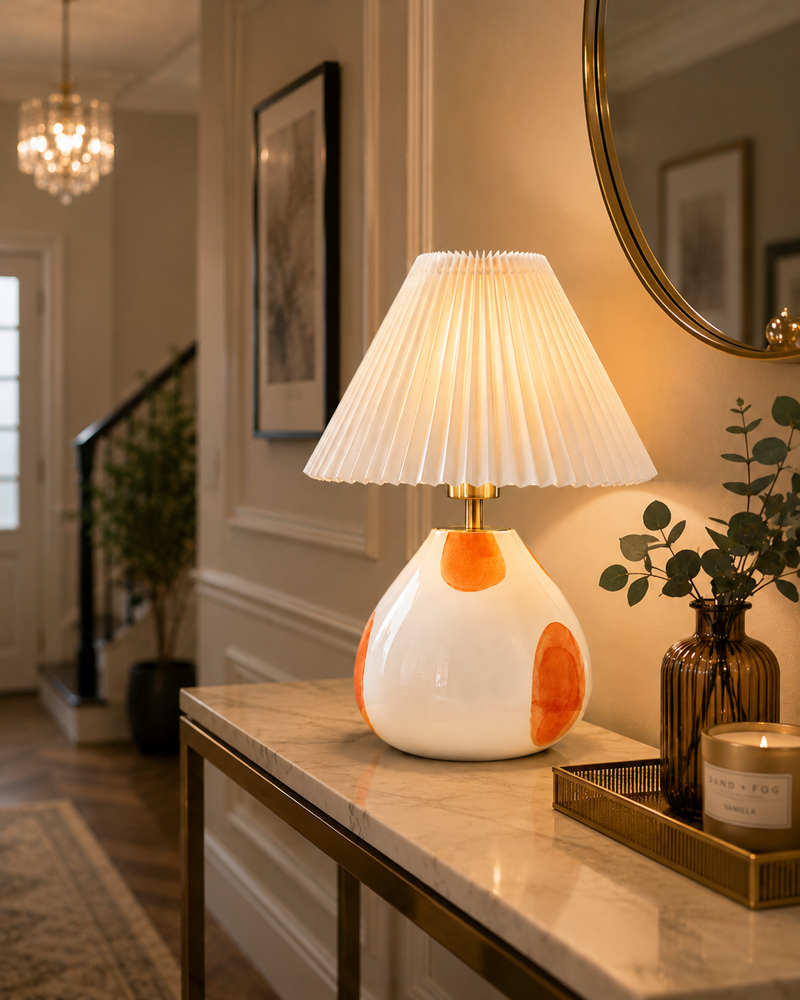 The Very Collection spotted glass table lamp with white pleated shade styled on a hallway console table, providing warm ambient lighting in a contemporary home entrance.