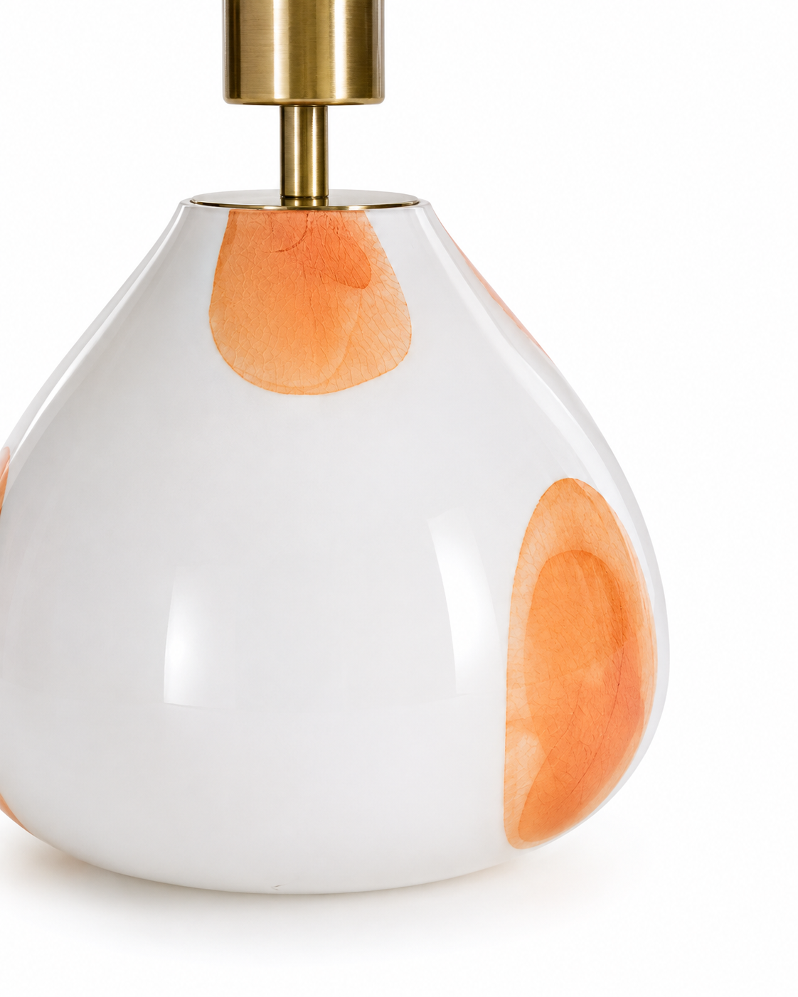 Close-up of The Very Collection spotted white glass table lamp base with decorative amber glass accents and brushed brass stem.